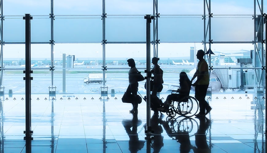 153535825_870x500.jpg family including person using a wheelchair walking through an airport