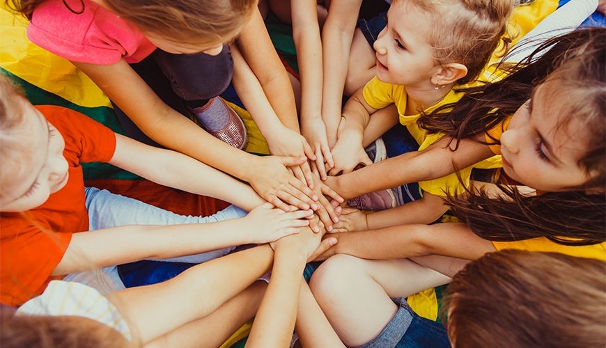 Children in a group holding hands