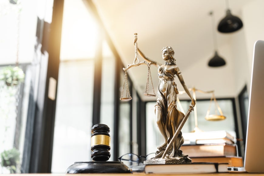 The Statue of Justice and legal gavel in office