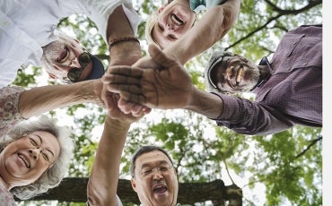 Diverse group of older people smiling in a circle