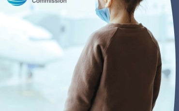 A young girl wearing a face mask looks out a window. Text reads ANNUAL REPORT 2021-2022 and features the Australian Human Rights Commission logo.